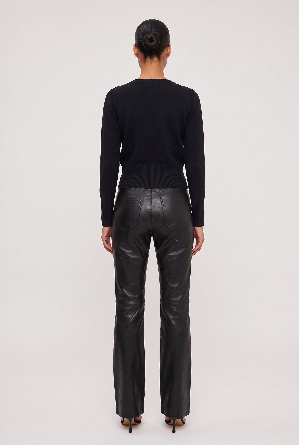 
model wearing Vegan Leather Flare Pant posing Back View