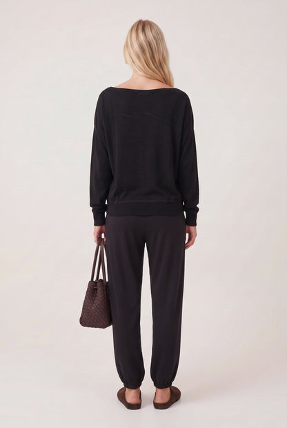 
model wearing Drop Slv Boat Neck Top posing Back View