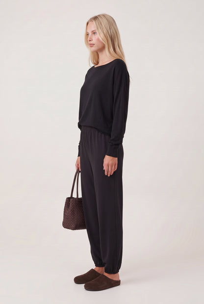 
model wearing Drop Slv Boat Neck Top posing Side View