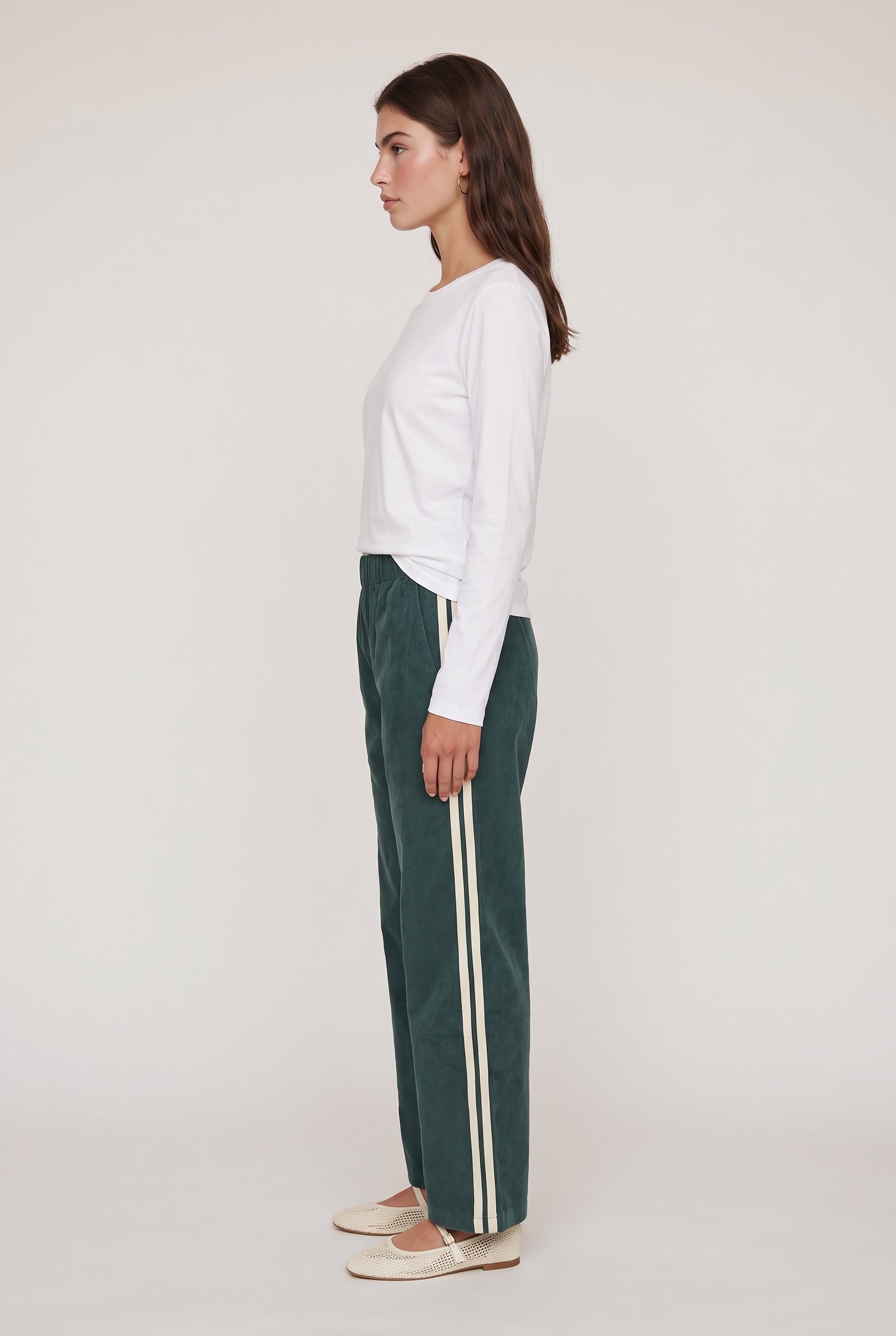 [GREEN] model wearing DOWNTOWN TRACK PANT posing Side View