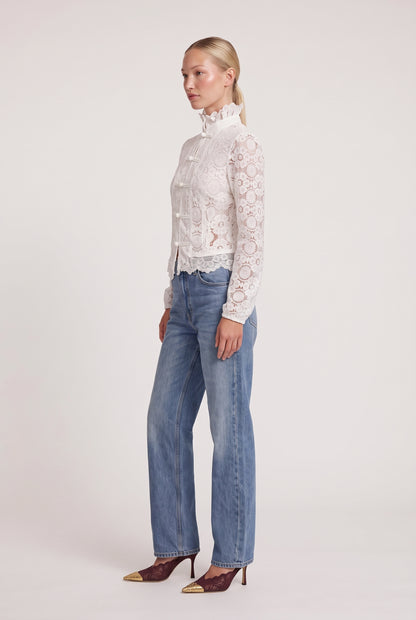 
model wearing Overtime Blouse posing Side View