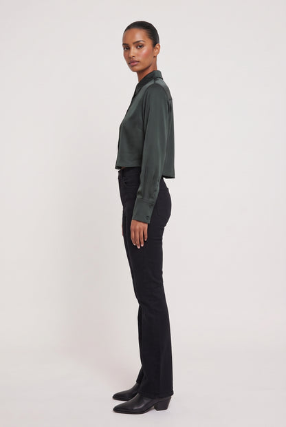 
model wearing High Low Satin Shirt posing Side View