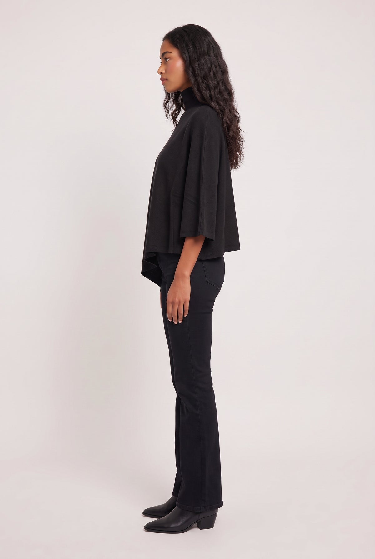 [JETBLACK] model wearing Tiwa Cape posing Side View