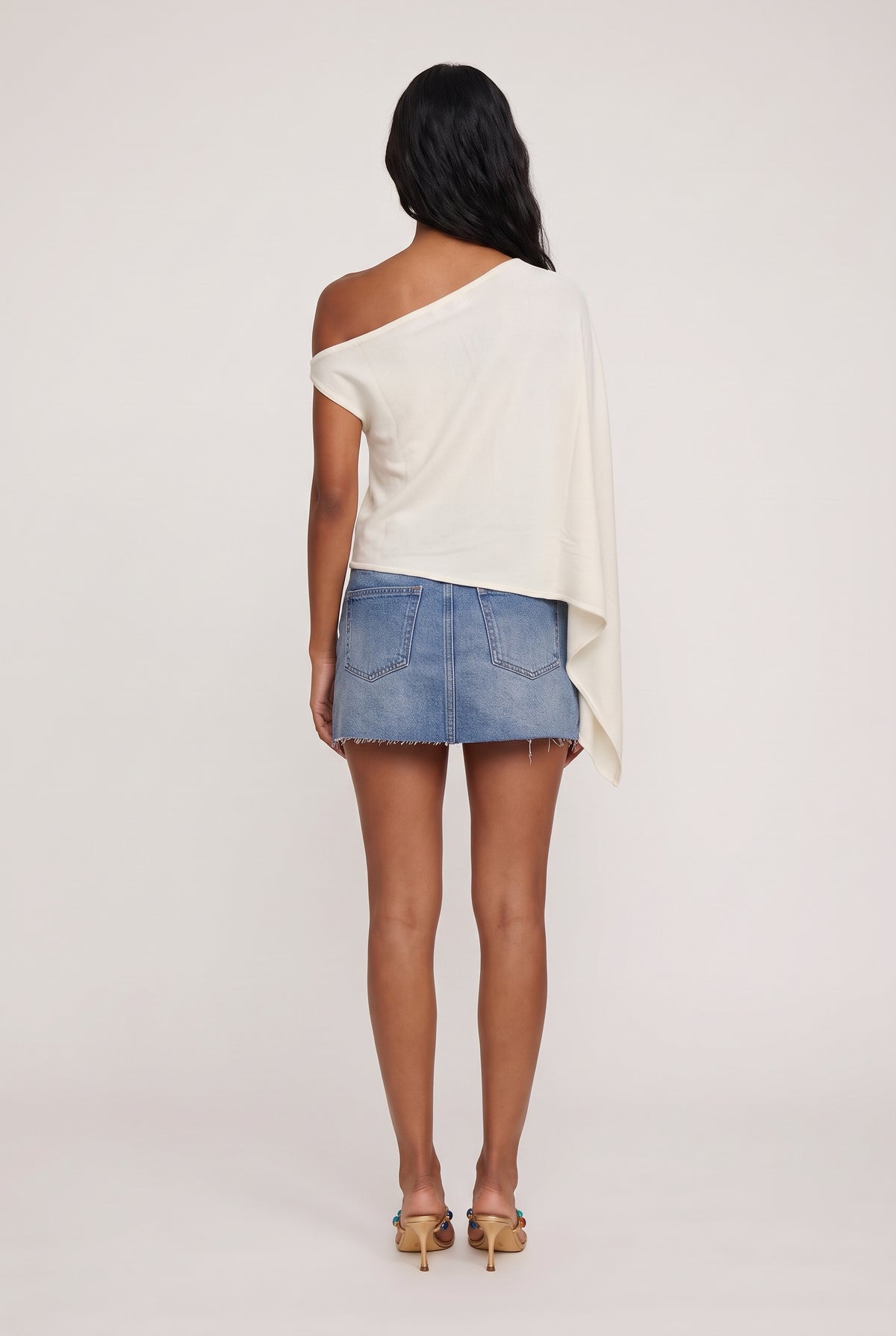 
model wearing Tyla Poncho posing Back View