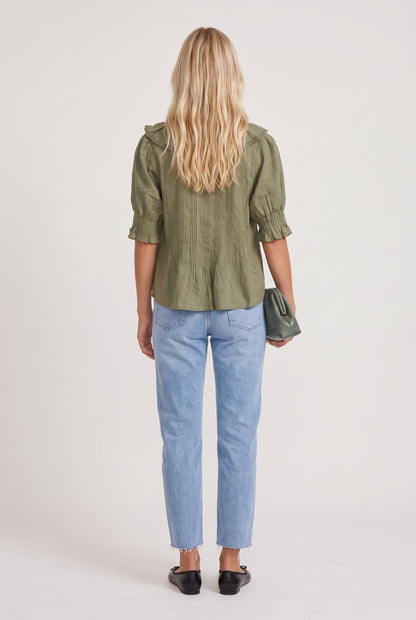 
model wearing Sage Ruffled Lace Trim Top posing Back View