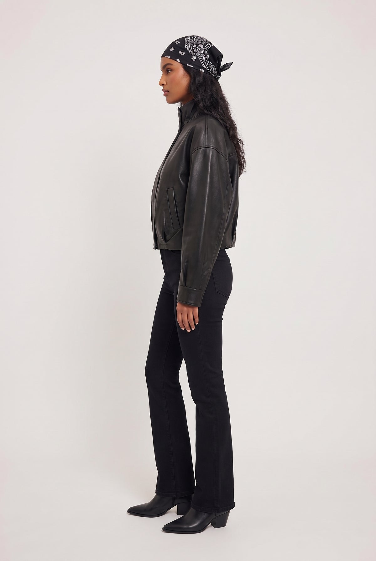 [BLACK] model wearing Corin Bubble Hem Jacket posing Side View