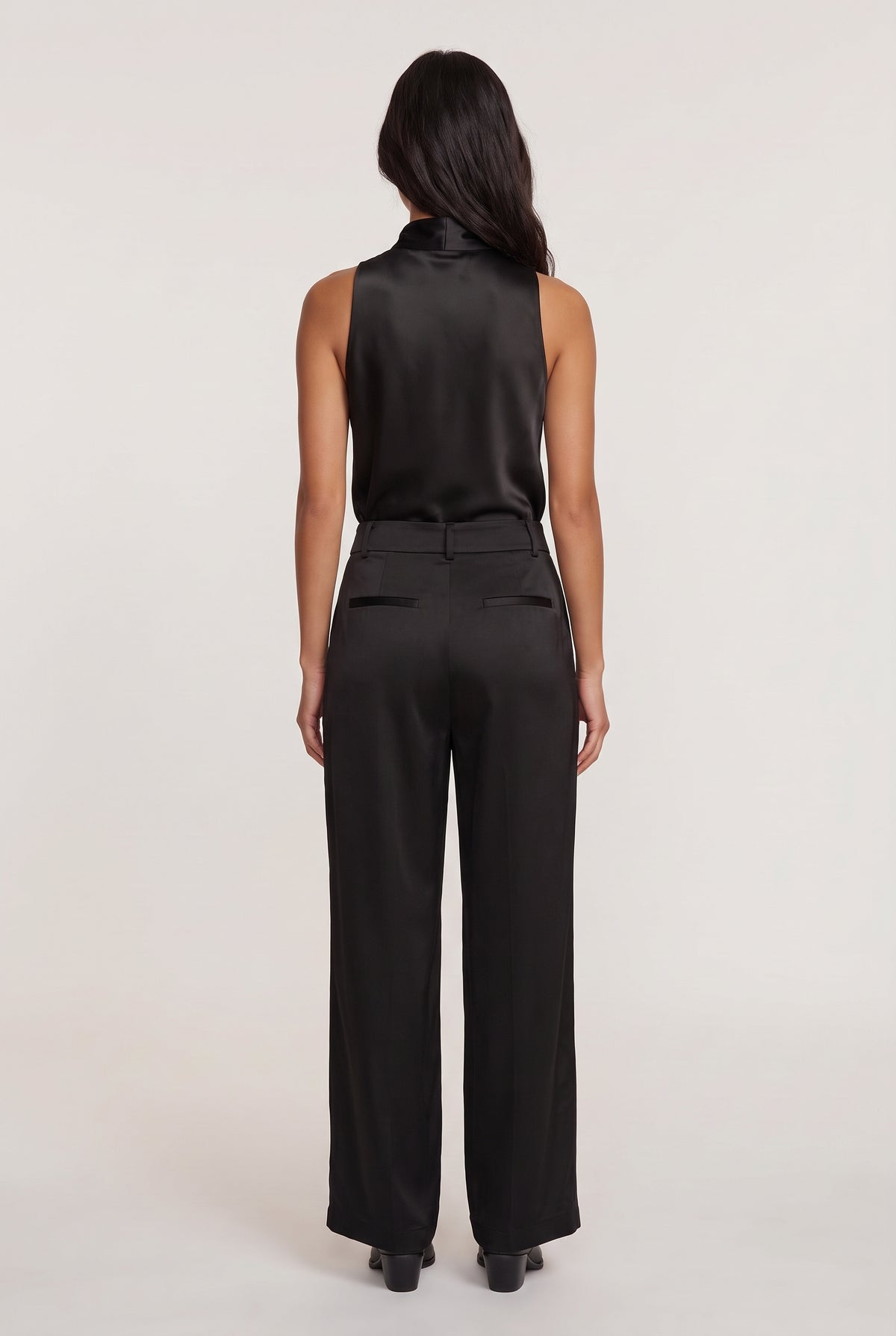 
model wearing Aman Satin Trouser posing back View