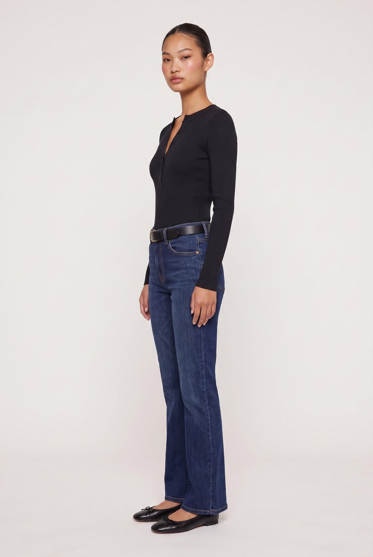 [BLACK] model wearing Rowan Ribbed L/s Henley posing Side View